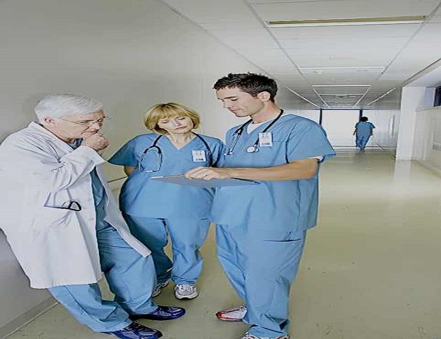 Doctors having discussion in hospital corridor